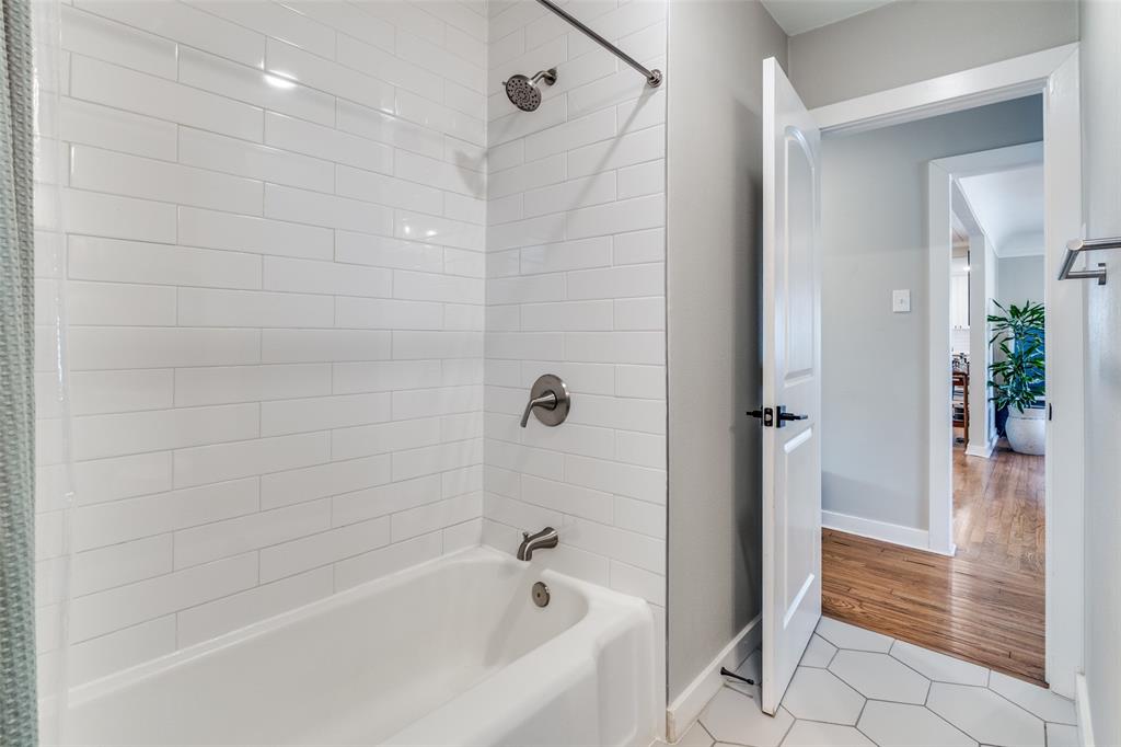 4245 Concho Street Dallas, TX 75206 - Photo 19 of 30 Full bath with light tile patterned floors and shower combination