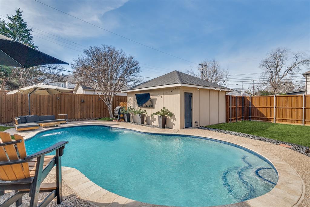 4245 Concho Street Dallas, TX 75206 - Photo 22 of 30 View of swimming pool with a fenced backyard, patio surround, and an outdoor structure