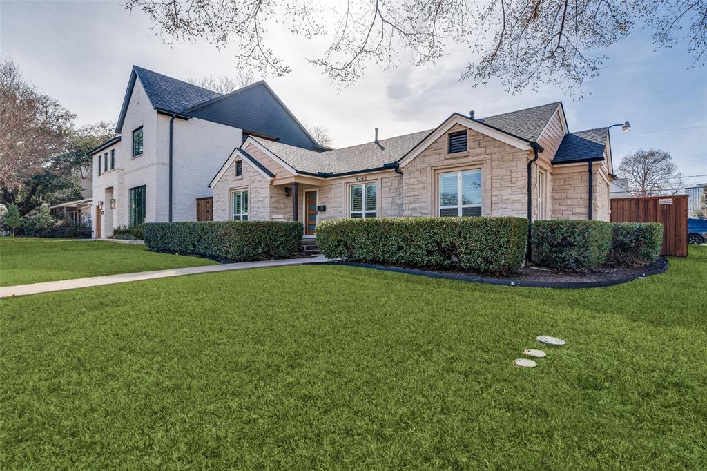 4245 Concho Street Dallas, TX 75206 - Photo 25 of 30 View of front of property featuring stone siding, a front yard, and a shingled roof