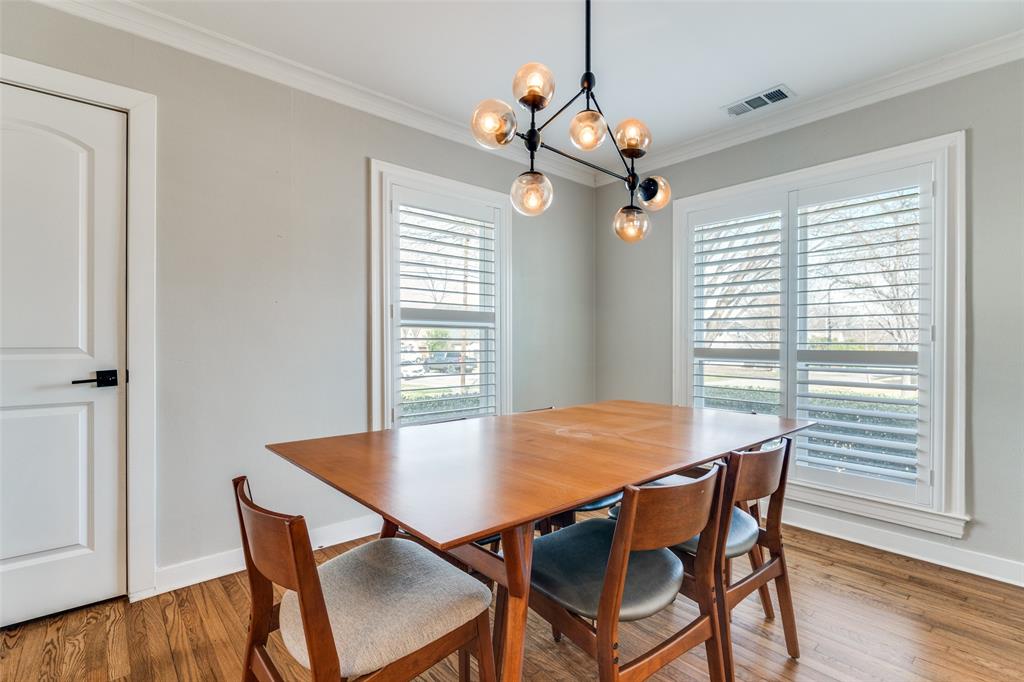 4245 Concho Street Dallas, TX 75206 - Photo 9 of 30 Dining area with wood finished floors, crown molding, and a chandelier