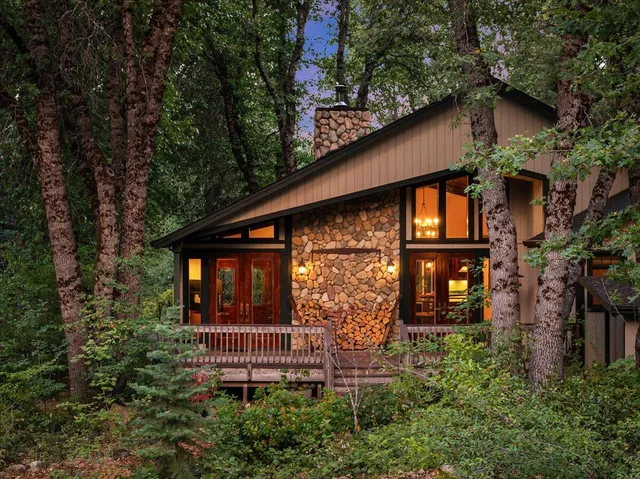 a front view of a house with plants