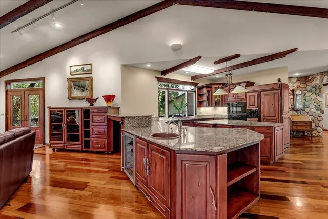 a kitchen with stainless steel appliances granite countertop a sink counter space and cabinets