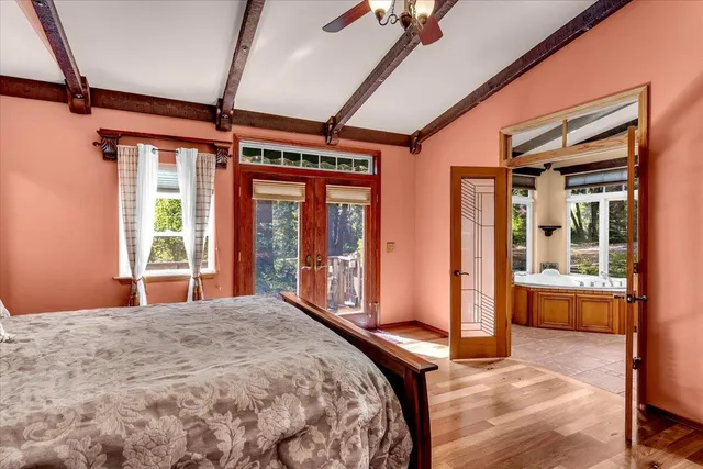 a bedroom with a large bed and balcony