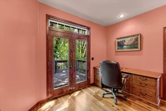 a view of a workspace with furniture and a window