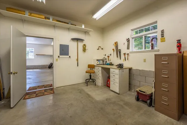 a view of a house with backyard and sitting area