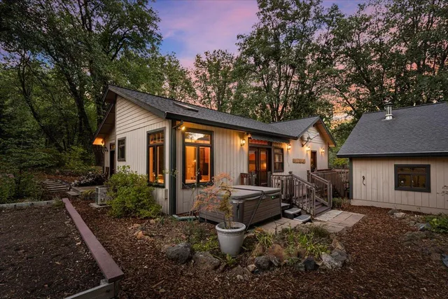 a view of a house with backyard sitting area and garden