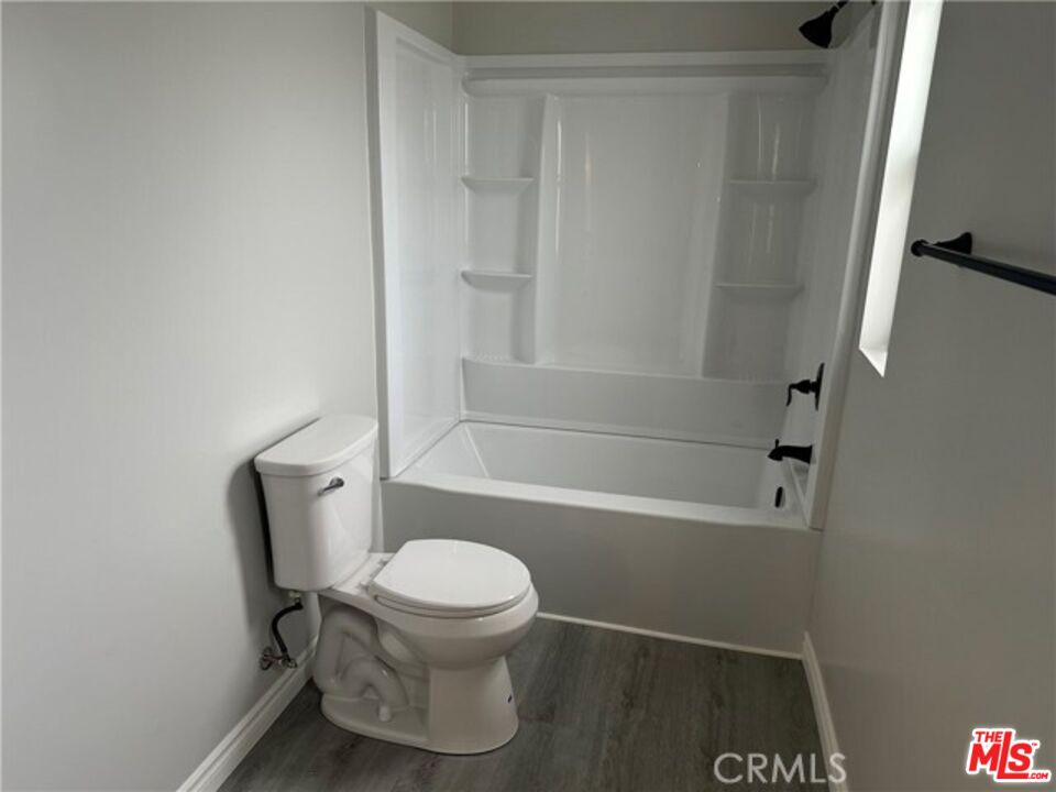 9391 California Avenue, Unit 89 Riverside, CA 92503 - Photo 10 of 16 a white toilet sitting next to a bath tub