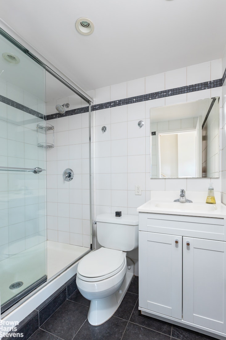2 Cornelia Street, Unit 404 Manhattan, NY 10014 - Photo 10 of 13 a bathroom with a sink a toilet and shower