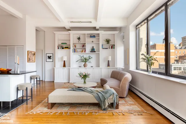 a spacious bedroom with a bed and a large window