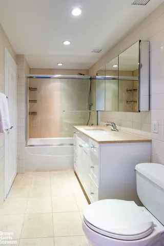 a bathroom with a sink a toilet a mirror and vanity