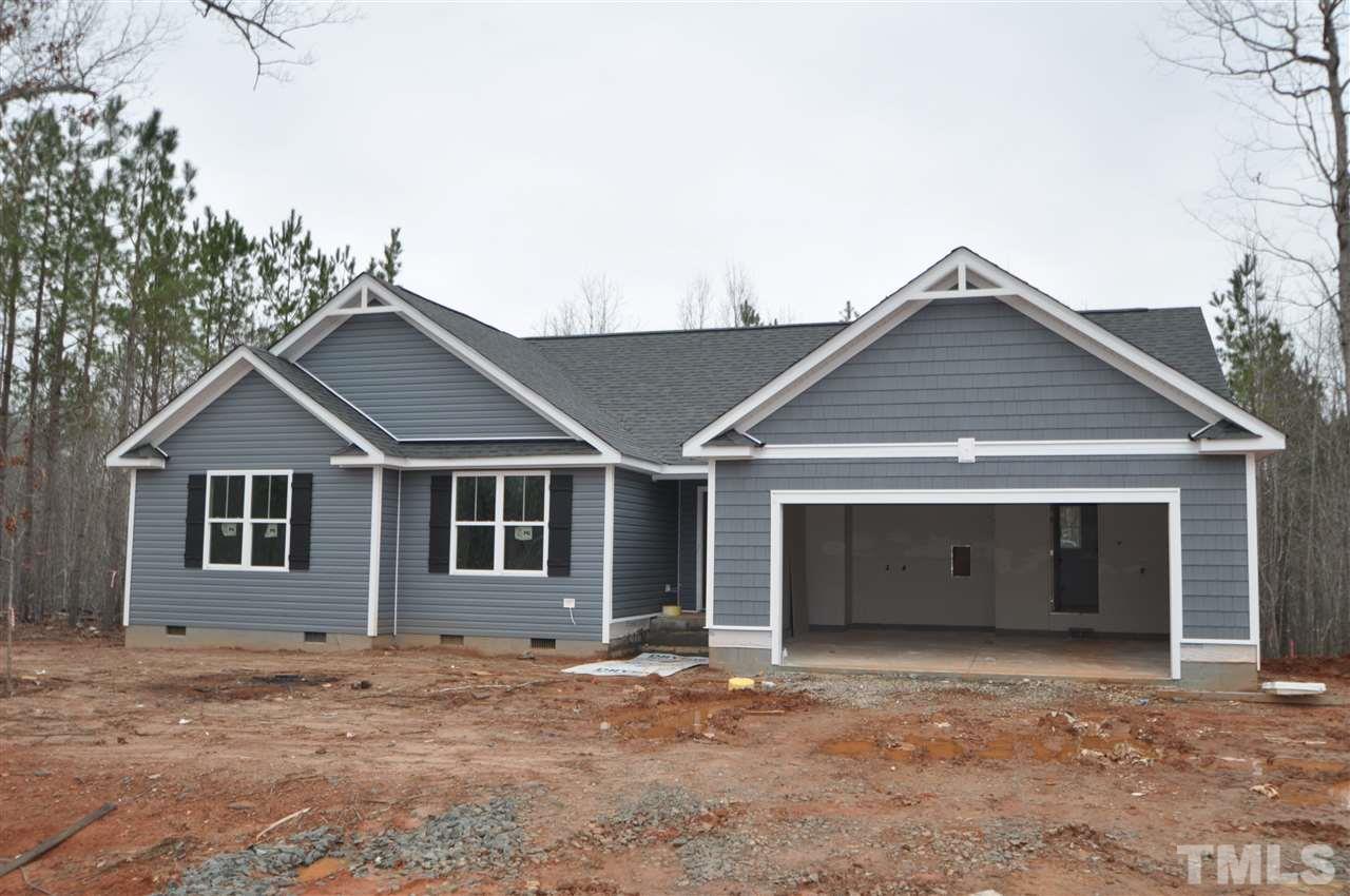 20 Mullins Pond Rd Spring Spring Hope, NC 27882 - Photo 1 of 6 a front view of a house with a garage and a yard