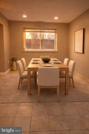 a dining room with furniture and window