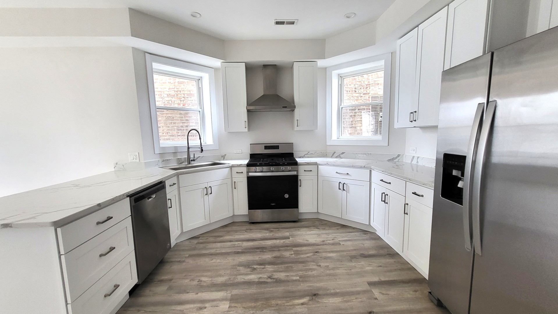2904 West Nelson Street, Unit 2 Chicago, IL 60618 - Photo 2 of 12 a kitchen with a refrigerator sink and cabinets
