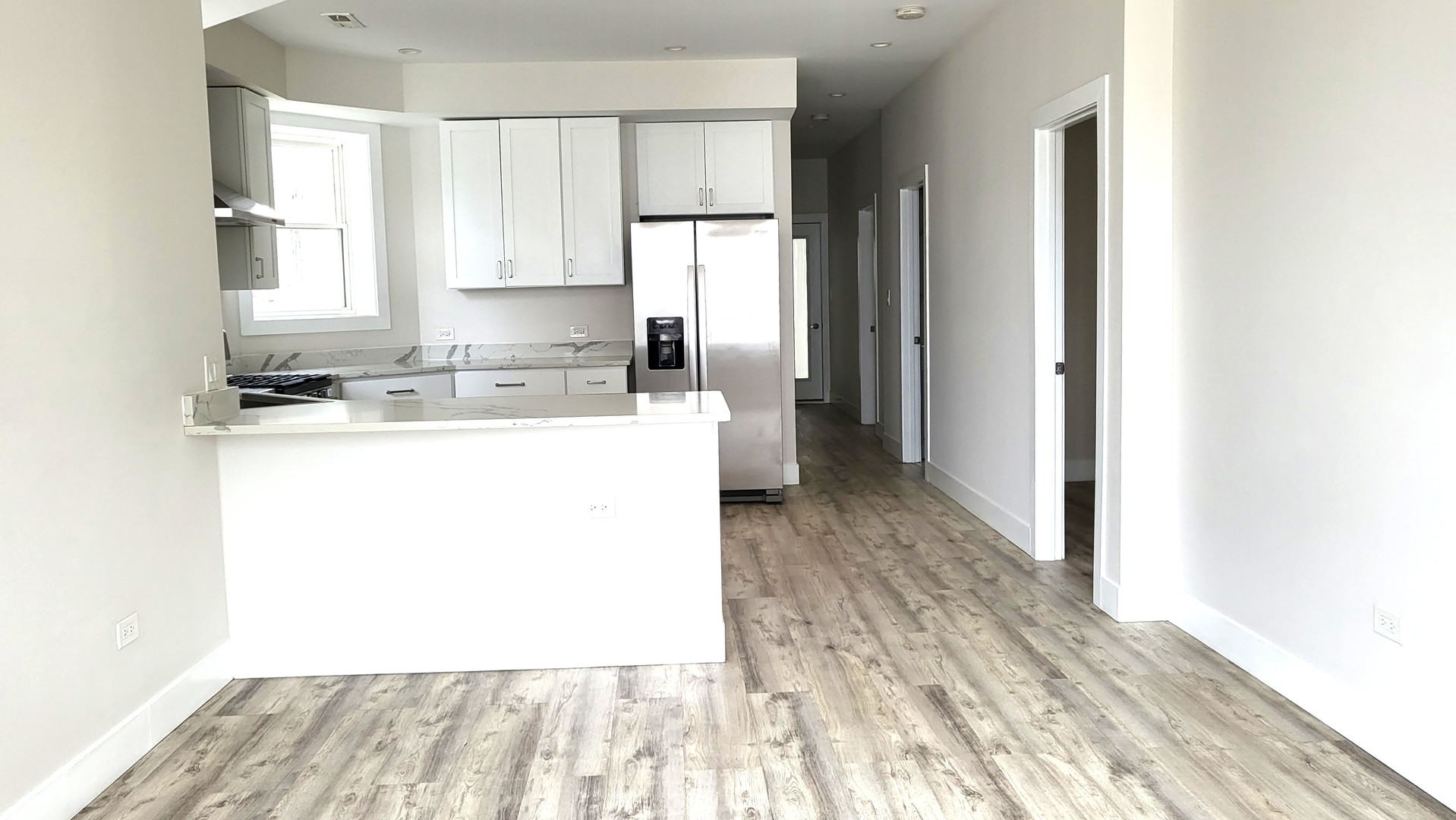 2904 West Nelson Street, Unit 2 Chicago, IL 60618 - Photo 6 of 12 a kitchen with a sink a stove a refrigerator and a microwave