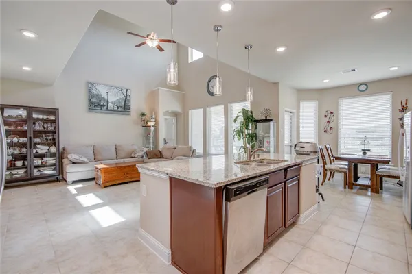 a kitchen with stainless steel appliances granite countertop a lot of counter space