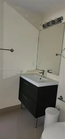 a room with a sink and a mirror