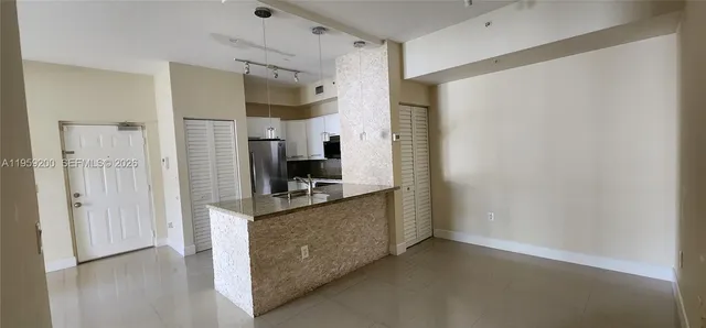a kitchen with stainless steel appliances a refrigerator and a stove top oven