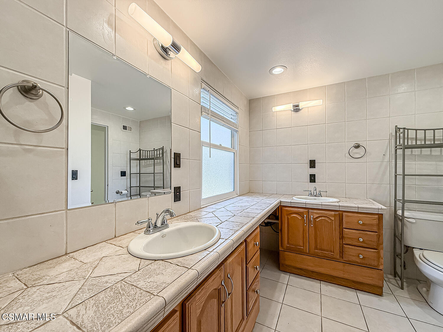 2561 Heywood Street Simi Valley, CA 93065 - Photo 11 of 31 a spacious bathroom with a granite countertop sink toilet and a mirror