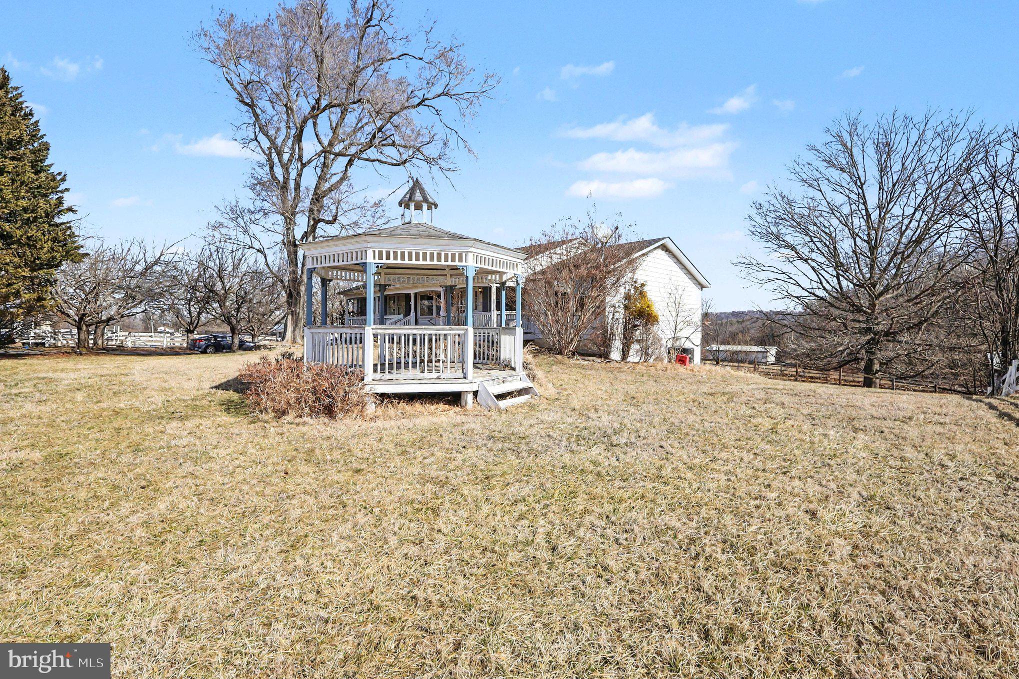 22244 Sam Fred Road Middleburg, VA 20117 - Photo 20 of 51 a front view of a house with a yard covered in snow