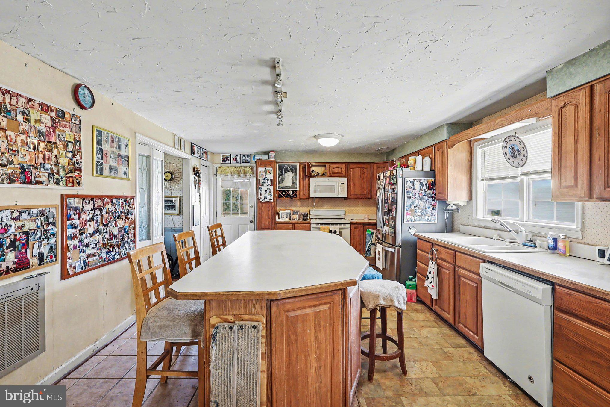 22244 Sam Fred Road Middleburg, VA 20117 - Photo 22 of 51 a table and chairs in a room with kitchen view