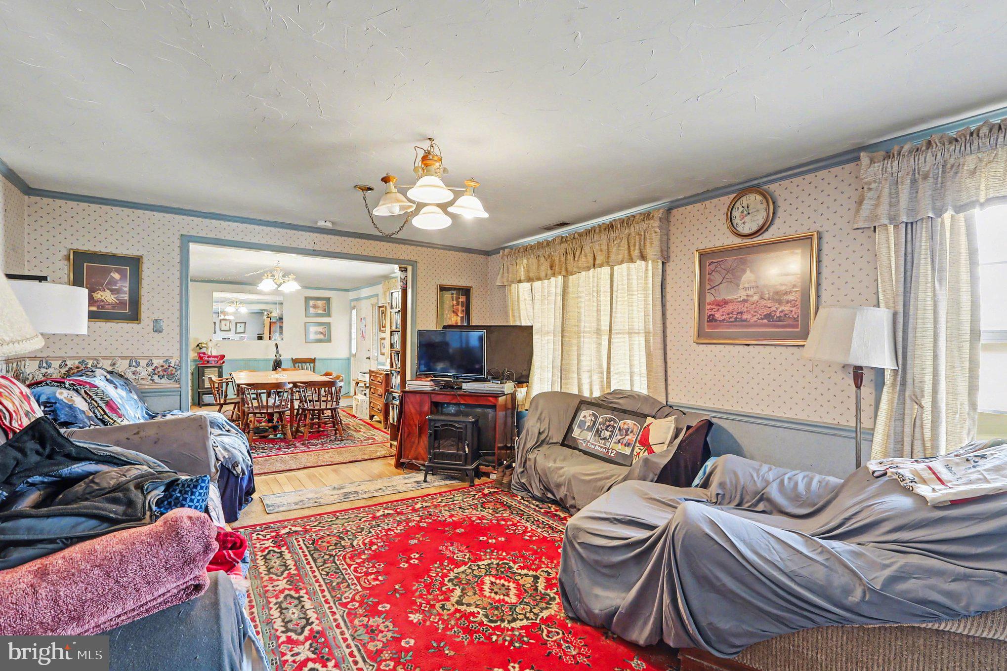 22244 Sam Fred Road Middleburg, VA 20117 - Photo 28 of 51 a living room with furniture and a flat screen tv
