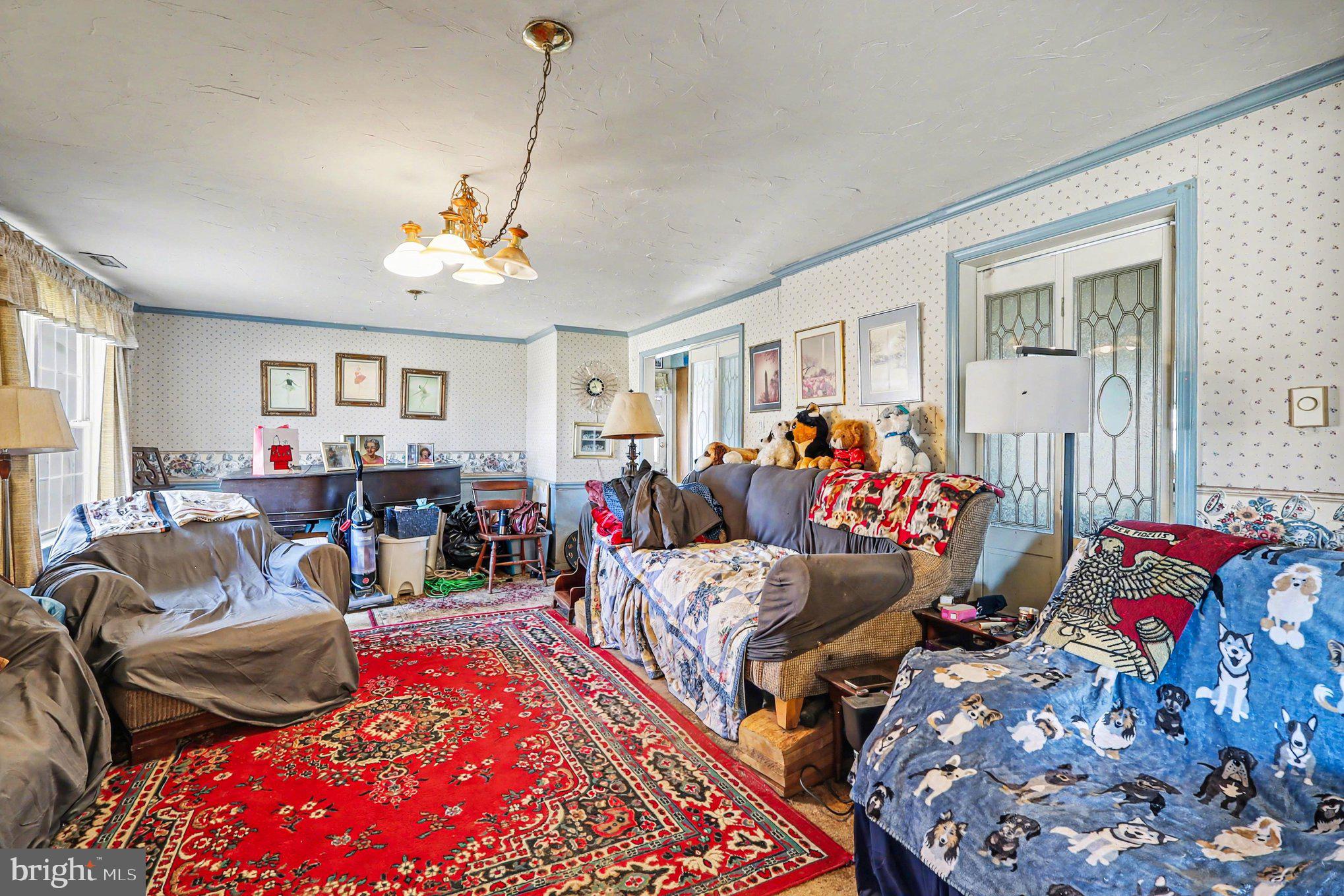 22244 Sam Fred Road Middleburg, VA 20117 - Photo 29 of 51 a living room filled with furniture and a chandelier