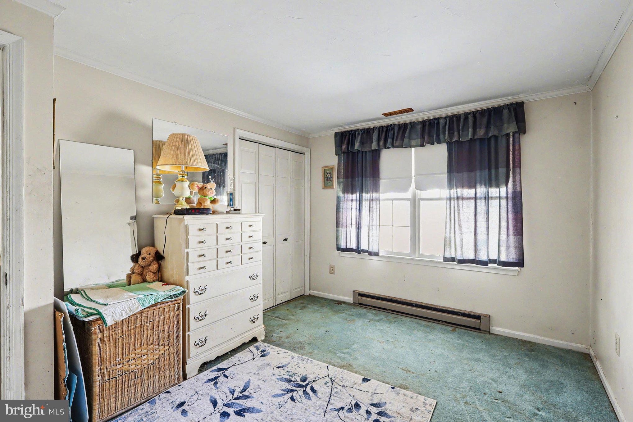 22244 Sam Fred Road Middleburg, VA 20117 - Photo 35 of 51 a bedroom with a bed and wooden floor