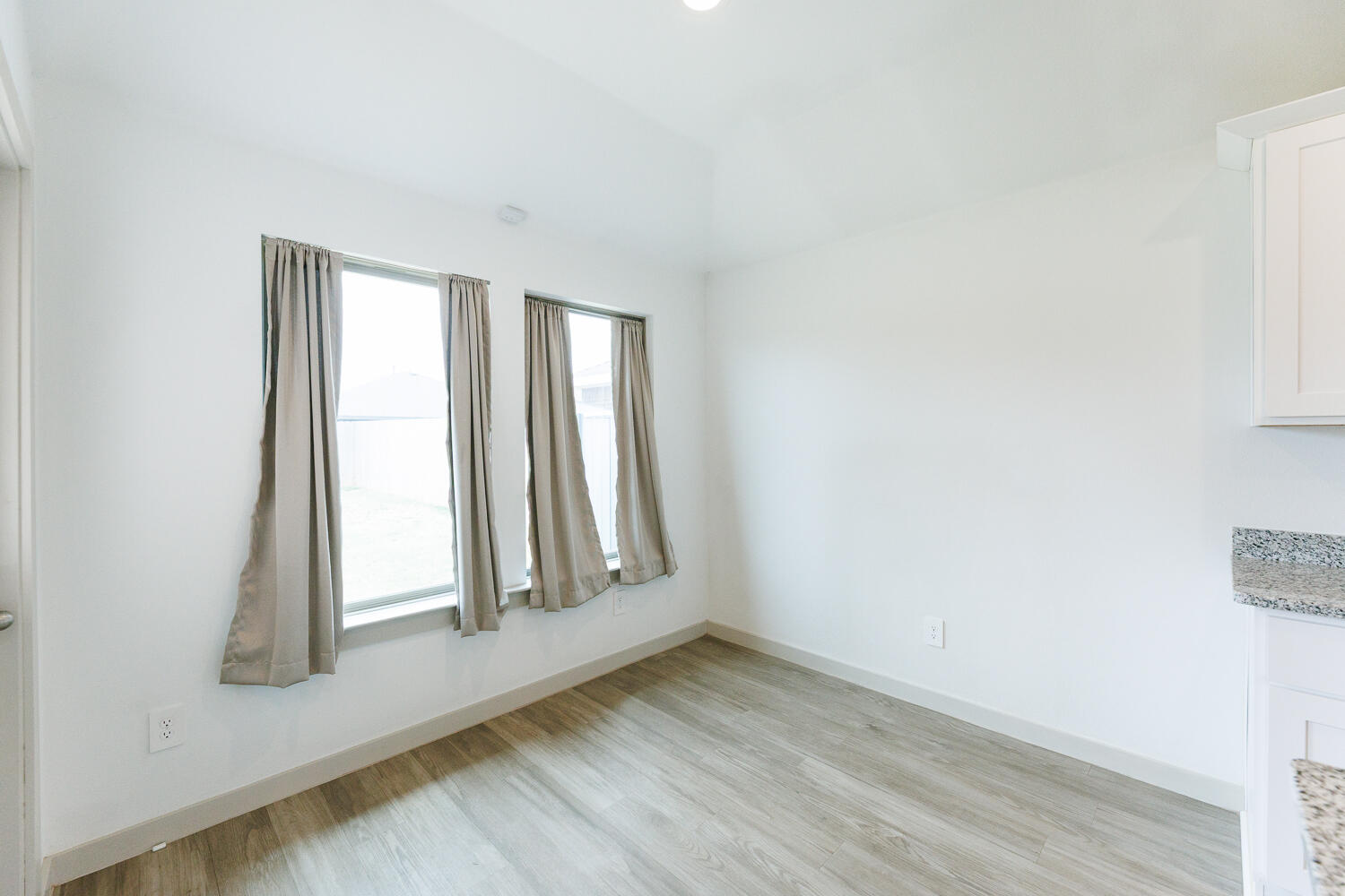 2305 150th Street Lubbock, TX 79423 - Photo 17 of 39 an empty room with wooden floor and a window