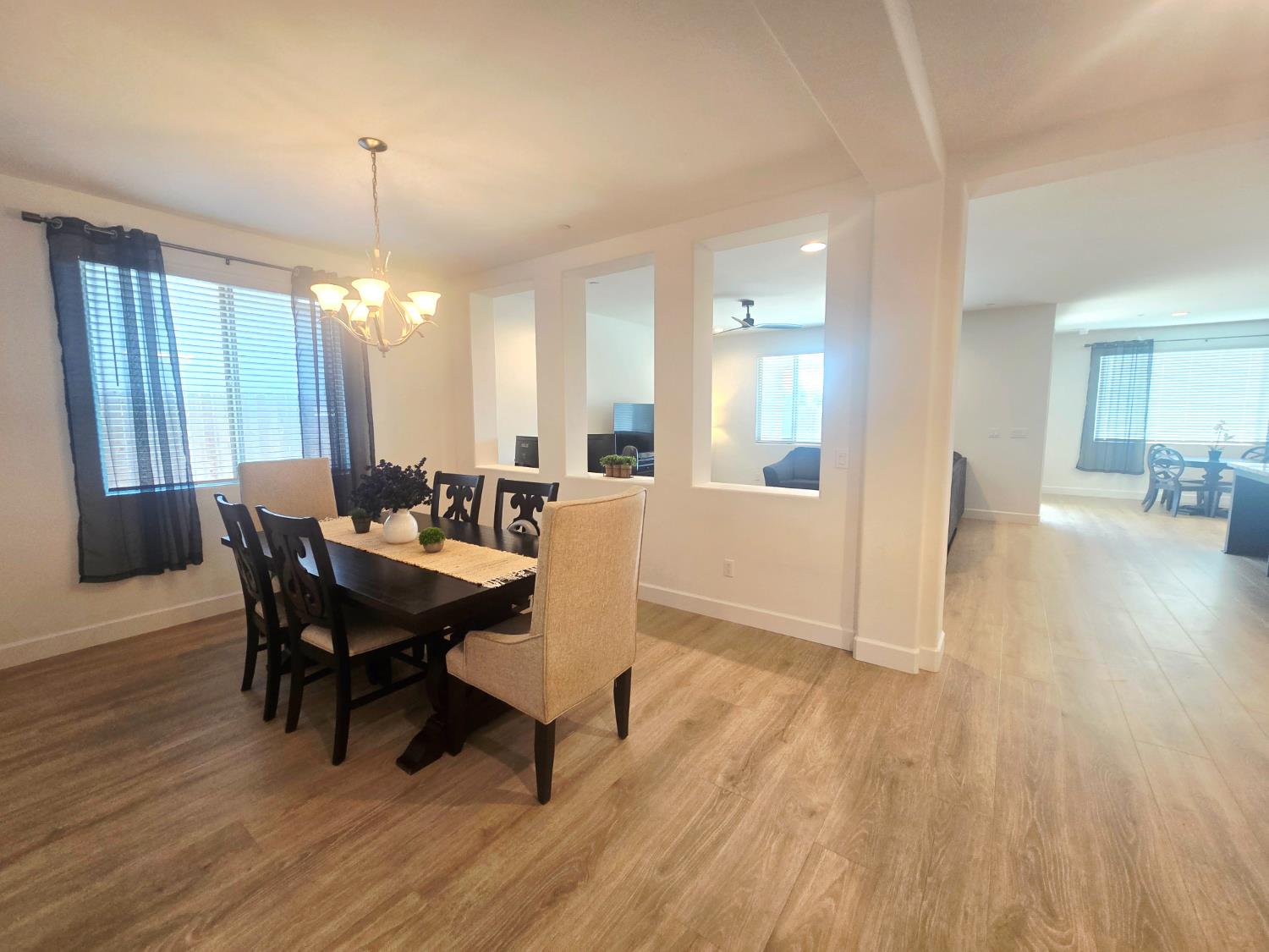 117 Emperor Way Dinuba, CA 93618 - Photo 11 of 32 a view of a dining room with furniture and wooden floor