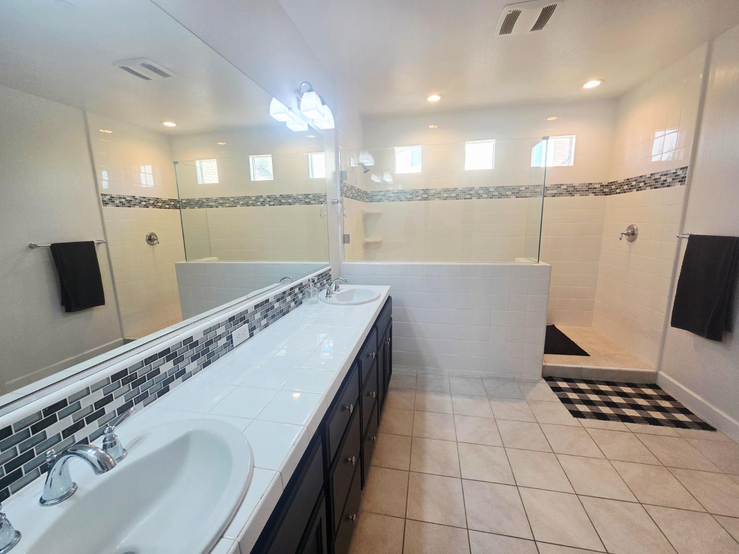 117 Emperor Way Dinuba, CA 93618 - Photo 23 of 32 a bathroom with a sink a toilet a mirror and shower