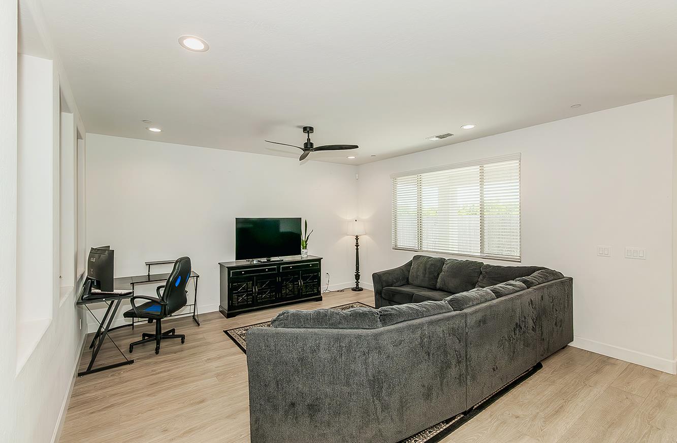 117 Emperor Way Dinuba, CA 93618 - Photo 5 of 32 a living room with furniture and a flat screen tv
