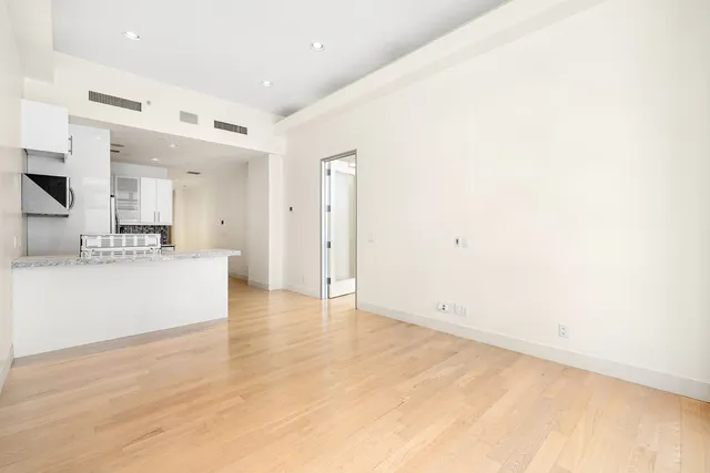 a kitchen with stainless steel appliances a refrigerator sink and microwave