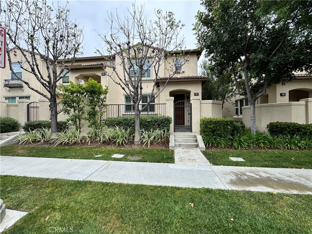 a front view of house with a garden