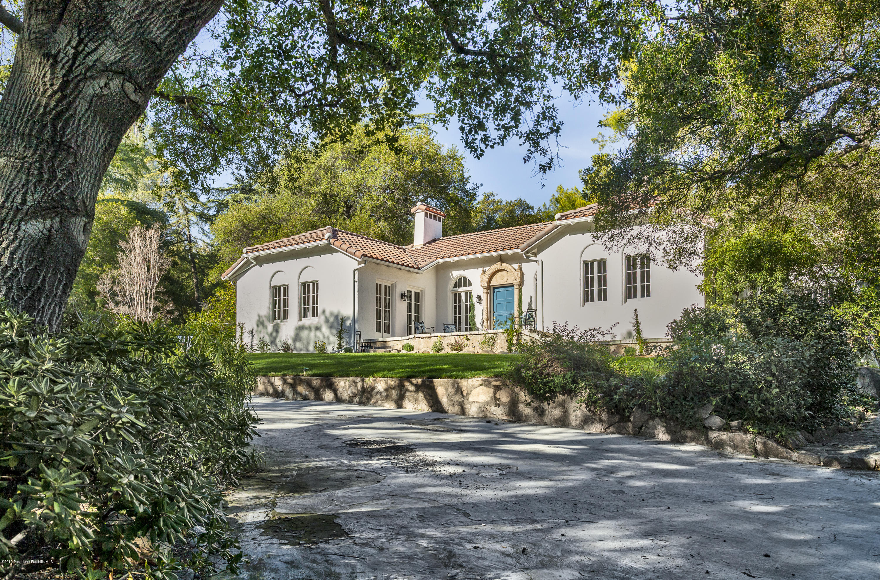 3130 Maiden Lane Altadena, CA 91001 - Photo 82 of 89 a view of a white house with a big yard and large trees