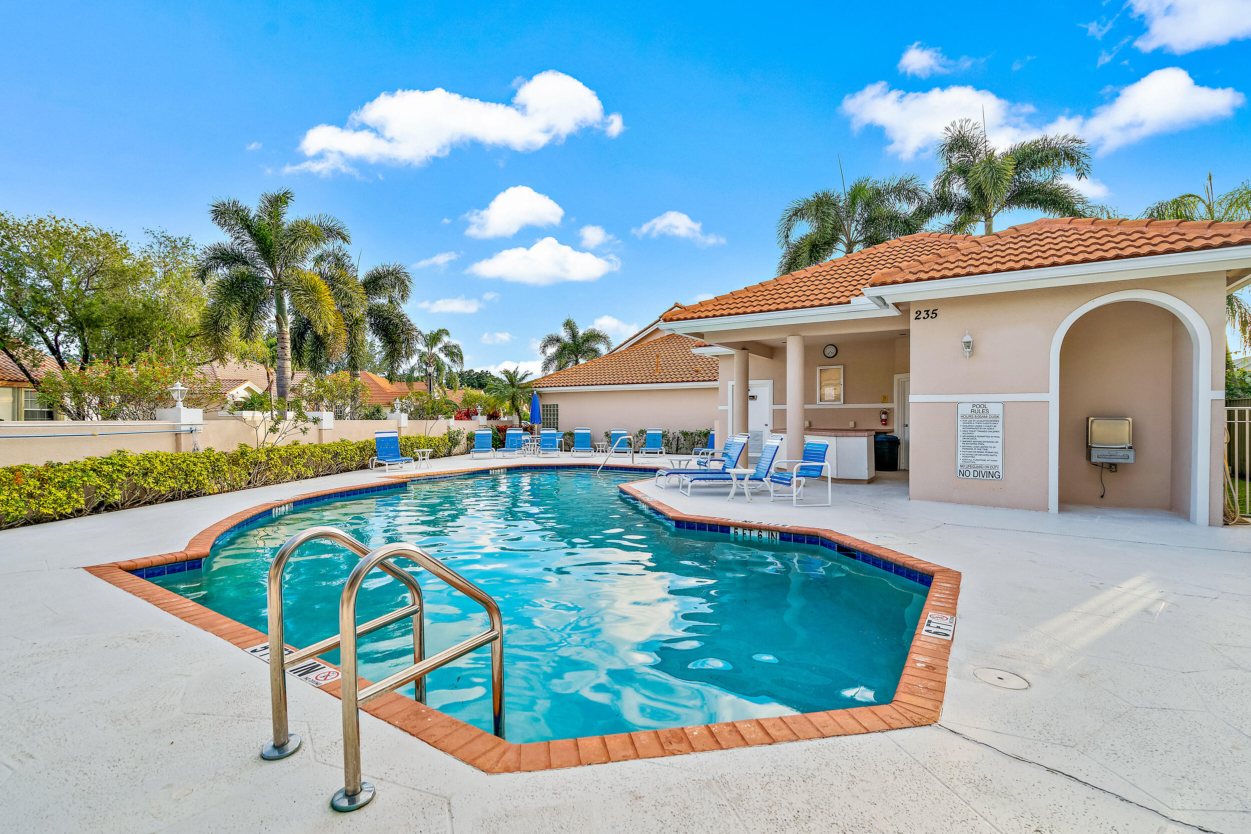 207 Eagleton Estates Boulevard Palm Beach Gardens, FL 33418 - Photo 3 of 34 a view of a swimming pool with a lounge chairs