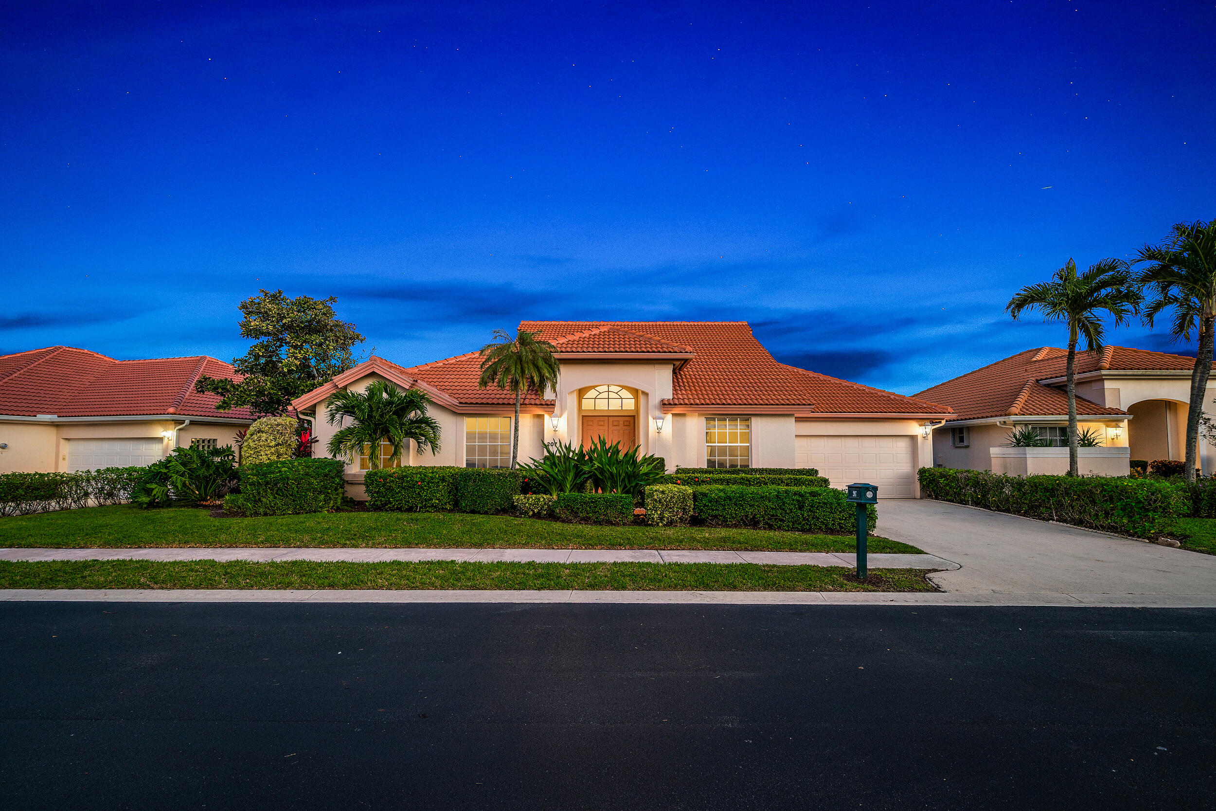 207 Eagleton Estates Boulevard Palm Beach Gardens, FL 33418 - Photo 32 of 34 a view of a white house with a big yard and potted plants