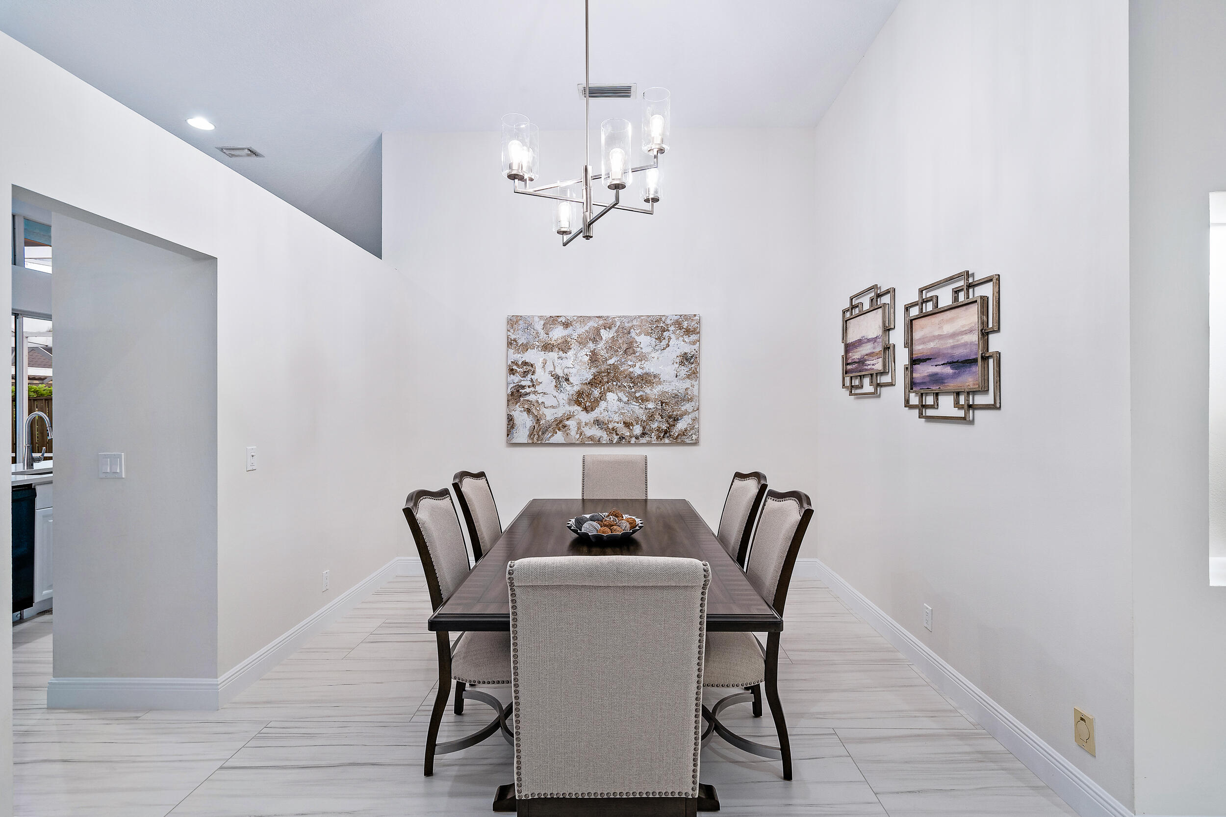 207 Eagleton Estates Boulevard Palm Beach Gardens, FL 33418 - Photo 10 of 34 a view of a dining room with furniture wooden floor and a chandelier