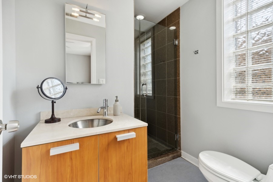 3012 West Addison Street, Unit 4S Chicago, IL 60618 - Photo 12 of 16 a bathroom with a sink a toilet and shower