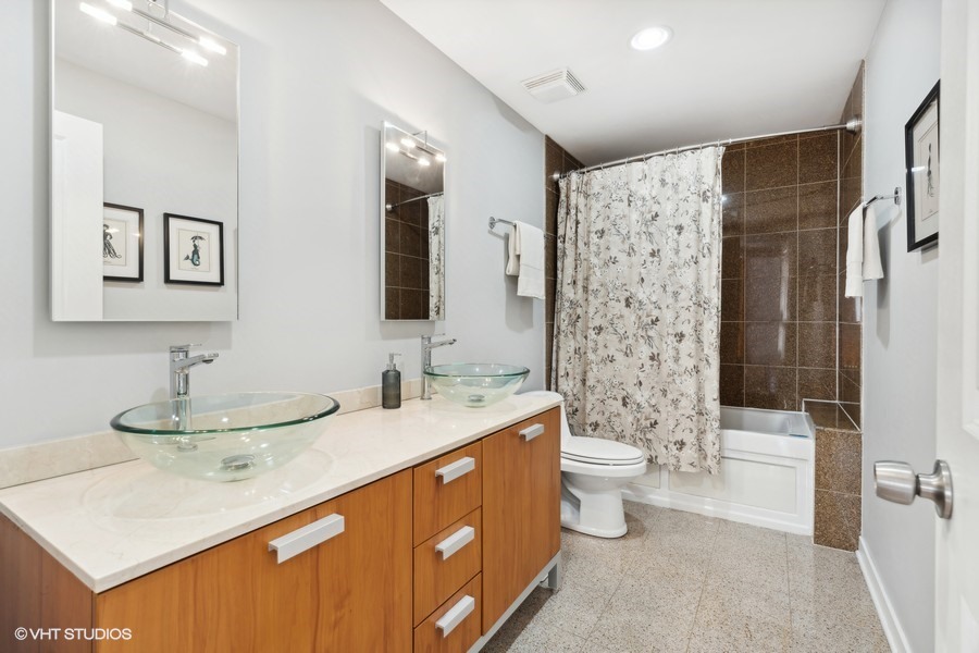 3012 West Addison Street, Unit 4S Chicago, IL 60618 - Photo 14 of 16 a bathroom with a double vanity sink toilet mirror and shower