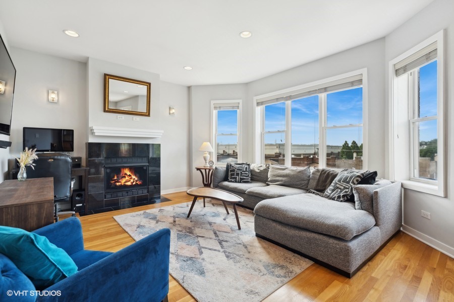 3012 West Addison Street, Unit 4S Chicago, IL 60618 - Photo 2 of 16 a living room with furniture fireplace and a large window