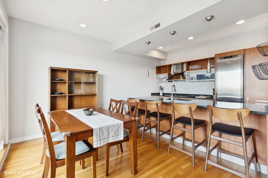 3012 West Addison Street, Unit 4S Chicago, IL 60618 - Photo 5 of 16 a view of a dining room with furniture and a rug