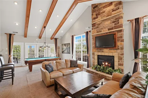a living room with furniture fireplace and flat screen tv