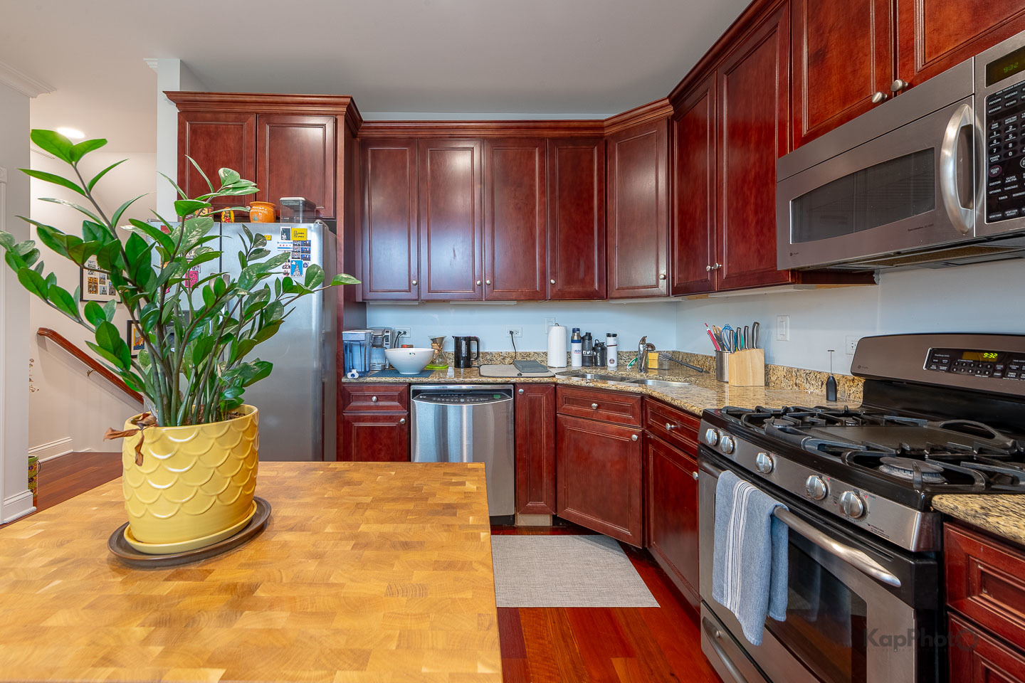 2340 West Adams Street, Unit 32 Chicago, IL 60612 - Photo 12 of 31 a kitchen with stainless steel appliances granite countertop a stove a sink and a microwave