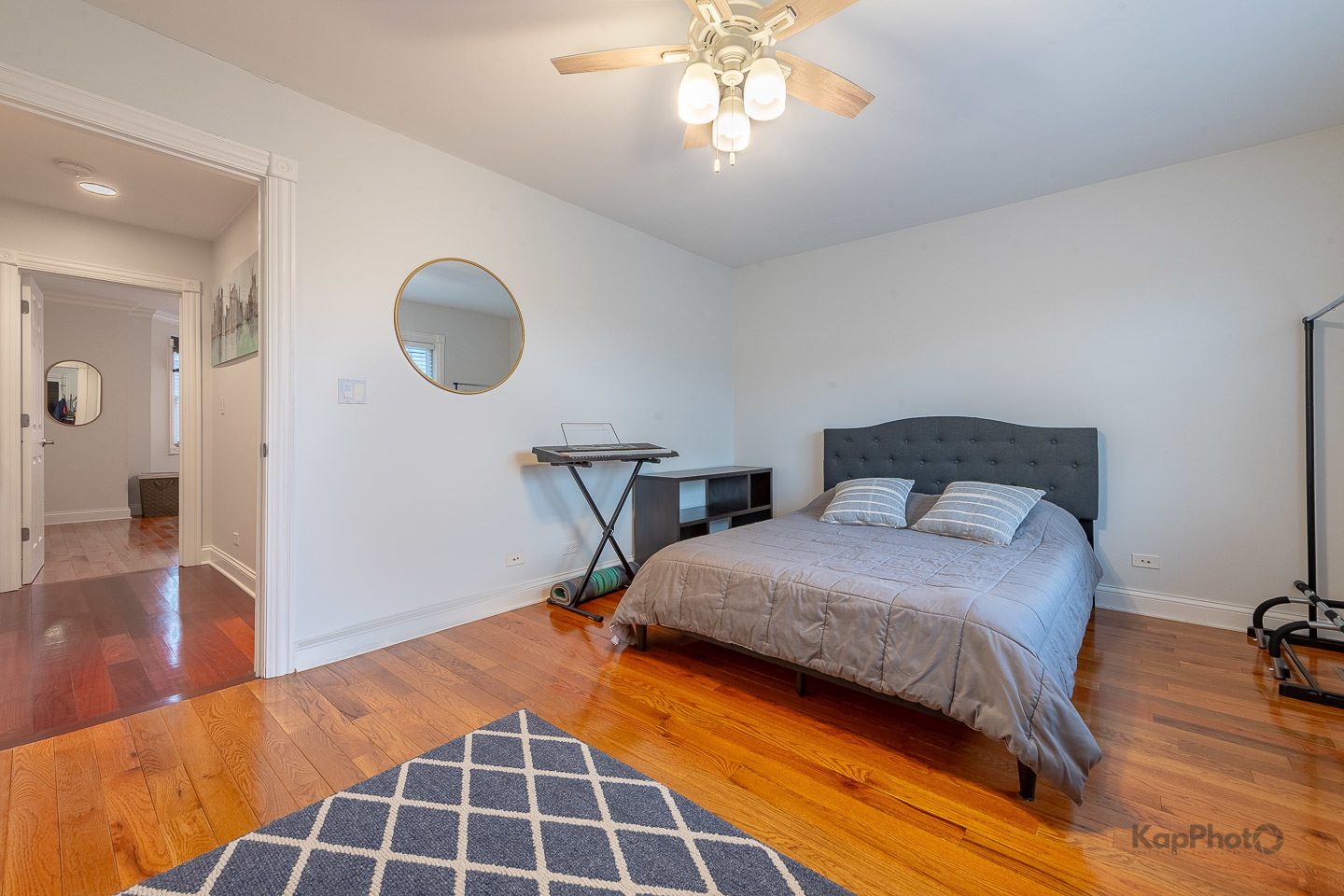 2340 West Adams Street, Unit 32 Chicago, IL 60612 - Photo 16 of 31 a bedroom with a bed and wooden floor