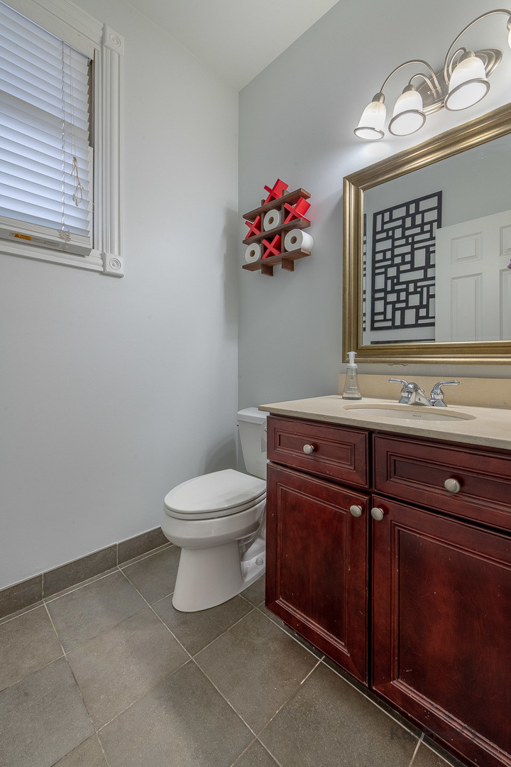 2340 West Adams Street, Unit 32 Chicago, IL 60612 - Photo 23 of 31 a bathroom with a sink a toilet and mirror