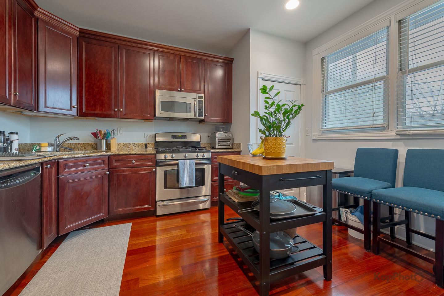2340 West Adams Street, Unit 32 Chicago, IL 60612 - Photo 10 of 31 a kitchen with stainless steel appliances granite countertop a stove top oven a sink dishwasher and cabinets with wooden floor