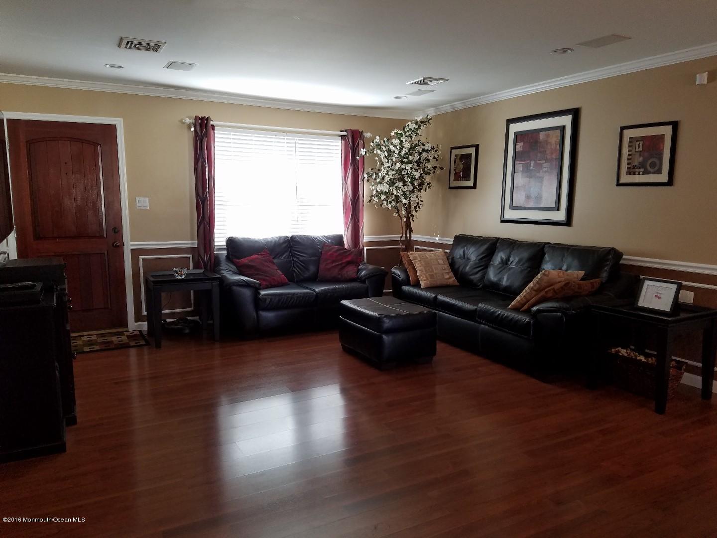 181 Stowaway Road Manahawkin, NJ 08050 - Photo 2 of 6 a living room with furniture and a flat screen tv