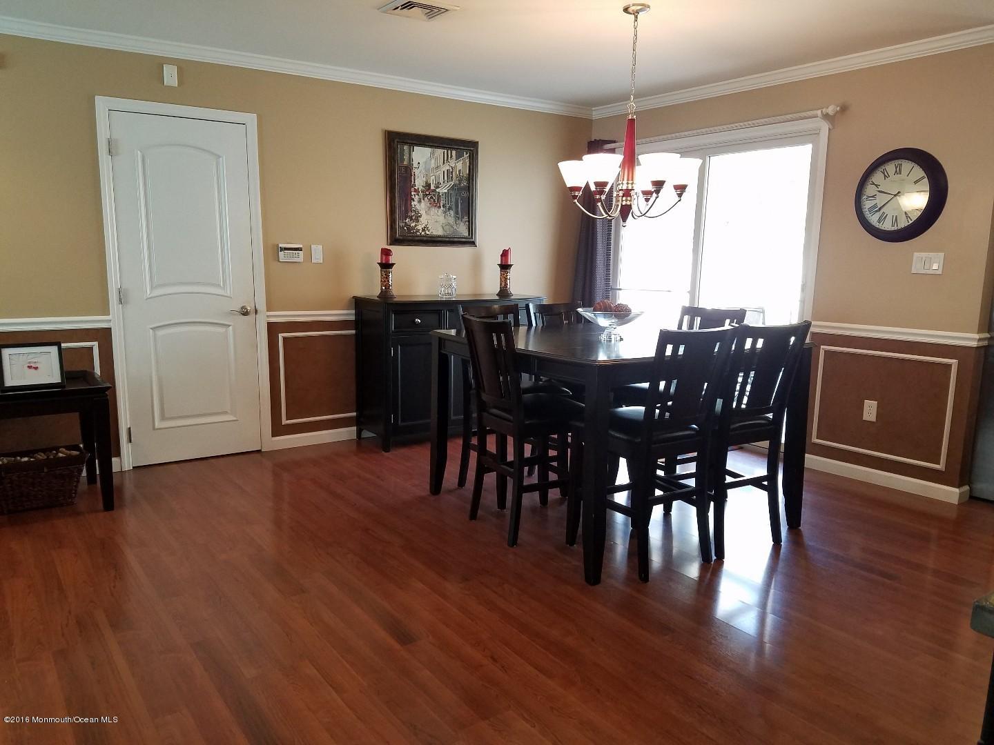 181 Stowaway Road Manahawkin, NJ 08050 - Photo 3 of 6 a view of a dining room with furniture window and wooden floor