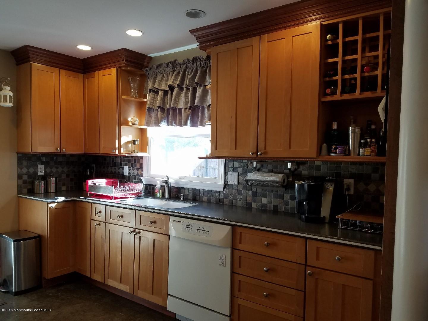181 Stowaway Road Manahawkin, NJ 08050 - Photo 4 of 6 a kitchen with stainless steel appliances granite countertop a sink a stove and cabinets