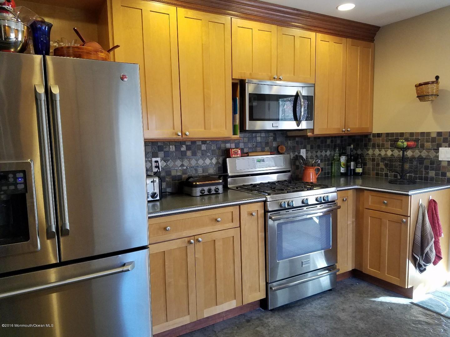181 Stowaway Road Manahawkin, NJ 08050 - Photo 5 of 6 a kitchen with stainless steel appliances granite countertop a refrigerator and a sink